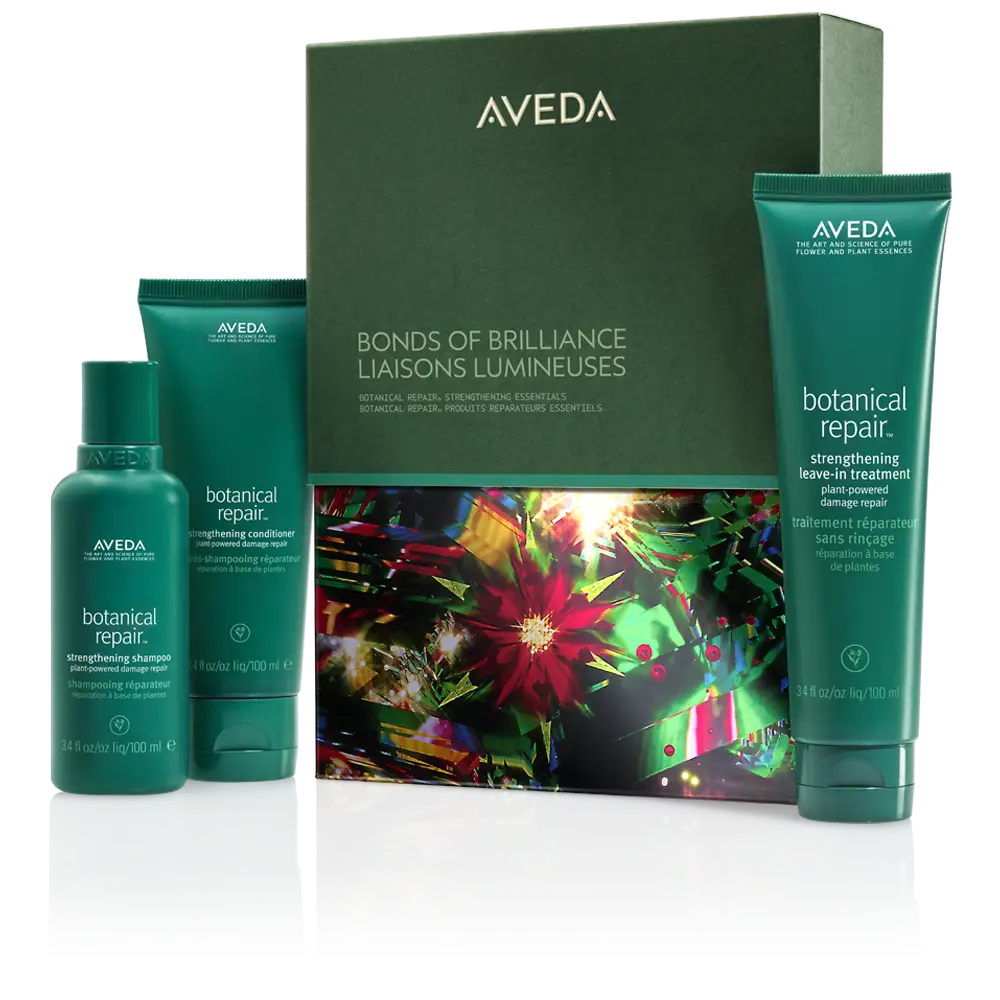 Aveda Bonds of Brilliance gift set with three green bottles and a decorative box, featuring botanical repair shampoo, conditioner, and leave-in treatment—perfect for winter hair care and festive hair ideas. - Spa Bleü in West Dundee, St. Charles and South Barrington, IL
