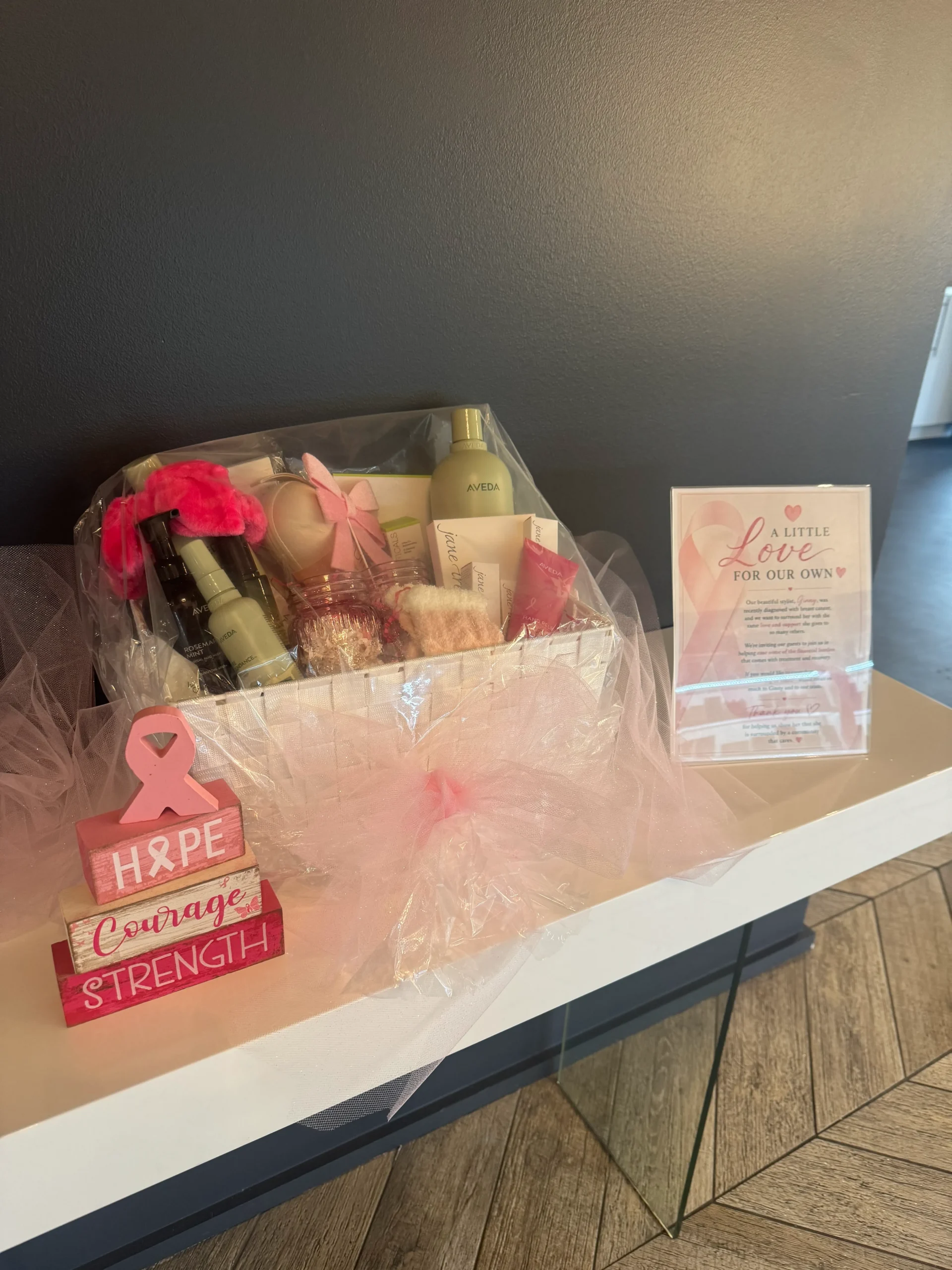- Spa Bleü in West Dundee, St. Charles and South Barrington, IL A gift basket with beauty products and pink decor sits on a counter next to a sign and a wooden block displaying the words “Hope, Courage, Strength” with a pink ribbon. - Spa Bleü in West Dundee, St. Charles and South Barrington, IL